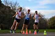 17 December 2023; Athletes from left, Nick Christie of USA, Nathaniel Seiler of Germany, and Michal Morvay of Slovakia, compete in the Men's 20km during the National Race Walking Championships and World Athletics Race Walking Tour Bronze at Raheny Park in Dublin. Photo by Sam Barnes/Sportsfile