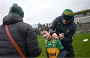 17 December 2023; Donegal manager Jim McGuinness signs the shirt of James McMurray, age 9, after the intercounty challenge match, in aid of North West Hospice, between Donegal and Roscommon at Fr Tierney Park in Ballyshannon, Donegal. Photo by Ramsey Cardy/Sportsfile