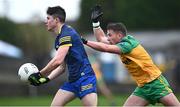 17 December 2023; Niall Higgins of Roscommon in action against Peadar Mogan of Donegal during the intercounty challenge match, in aid of North West Hospice, between Donegal and Roscommon at Fr Tierney Park in Ballyshannon, Donegal. Photo by Ramsey Cardy/Sportsfile
