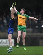 17 December 2023; Oisin Caulfield of Donegal in action against Niall Higgins of Roscommon during the intercounty challenge match, in aid of North West Hospice, between Donegal and Roscommon at Fr Tierney Park in Ballyshannon, Donegal. Photo by Ramsey Cardy/Sportsfile