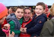 17 December 2023; Fionnuala O'Driscoll of O'Donovan Rossa celebrates with her nephews Fergal, left, and Darragh after the Currentaccount.ie LGFA All-Ireland Junior Club Championship final match between Claremorris of Mayo and O'Donovan Rossa of Cork at Parnell Park in Dublin. Photo by Ben McShane/Sportsfile