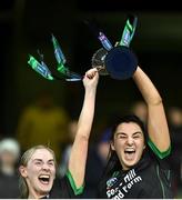 17 December 2023; Clanmaurice players Michelle Costello, left, and Niamh Leen lift the cup after their side's victory in the AIB Camogie All-Ireland Intermediate Club Championship final match between Clanmaurice of Kerry and Na Fianna of Meath at Croke Park in Dublin. Photo by Piaras Ó Mídheach/Sportsfile