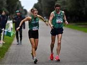 17 December 2023; Kate Veale of Ireland takes over from team-mate Brendan Boyce whilst competing in the marathon mixed relay during the National Race Walking Championships and World Athletics Race Walking Tour Bronze at Raheny Park in Dublin. Photo by Sam Barnes/Sportsfile