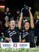 17 December 2023; Clanmaurice players Michelle Costello, left, and Niamh Leen lift the cup after their side's victory in the AIB Camogie All-Ireland Intermediate Club Championship final match between Clanmaurice of Kerry and Na Fianna of Meath at Croke Park in Dublin. Photo by Stephen Marken/Sportsfile