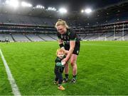 17 December 2023; Laura Collins of Clanmaurice celebrates with her son Ruadh Molloy son age 1, after the AIB Camogie All-Ireland Intermediate Club Championship final match between Clanmaurice of Kerry and Na Fianna of Meath at Croke Park in Dublin. Photo by Piaras Ó Mídheach/Sportsfile