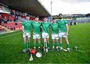 21 October 2023; Ireland players, from left, Paddy Purcell, Eoghan Cahill, Luca McCusker, Mickey Joe Egan and Ben Conneely after their side's victory in the 2023 Hurling Shinty International Game between Ireland and Scotland at Páirc Esler in Newry, Down. Photo by Piaras Ó Mídheach/Sportsfile