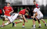 22 December 2023; Gordon Wood of Munster is tackled by Johnny Scott of Ulster during the Development Interprovincial match between Ulster and Munster at Newforge Sports Complex in Belfast. Photo by Ramsey Cardy/Sportsfile