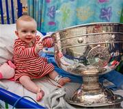 25 December 2023; Eight month old Holly Browne, from Carrigrohane, Cork, with the Sam Maguire Cup during the All-Ireland Senior Football Championship winners visit to Children's Health Ireland at Temple Street in Dublin. Photo by Ray McManus/Sportsfile