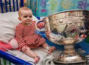 25 December 2023; Eight month old Holly Browne, from Carrigrohane, Cork, with the Sam Maguire Cup during the All-Ireland Senior Football Championship winners visit to Children's Health Ireland at Temple Street in Dublin. Photo by Ray McManus/Sportsfile