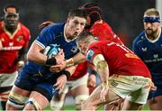 26 December 2023; Joe McCarthy of Leinster is tackled by Diarmuid Barron and Shane Daly of Munster during the United Rugby Championship match between Munster and Leinster at Thomond Park in Limerick. Photo by Brendan Moran/Sportsfile