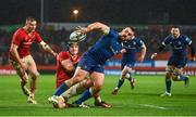 26 December 2023; Rónan Kelleher of Leinster offloads a pass as he is tackled by Gavin Coombes of Munster during the United Rugby Championship match between Munster and Leinster at Thomond Park in Limerick. Photo by Brendan Moran/Sportsfile