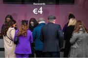 27 December 2023; Punters queue for racecards before racing on day two of the Leopardstown Christmas Festival at Leopardstown Racecourse in Dublin. Photo by David Fitzgerald/Sportsfile