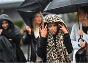 27 December 2023; Racegoers battle the rain on day two of the Leopardstown Christmas Festival at Leopardstown Racecourse in Dublin. Photo by David Fitzgerald/Sportsfile