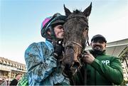 27 December 2023; Jockey Danny Mullins kisses Meetingofthewaters alongside groom Imran Haider after winning the Paddy Power Steeplechase on day two of the Leopardstown Christmas Festival at Leopardstown Racecourse in Dublin. Photo by David Fitzgerald/Sportsfile