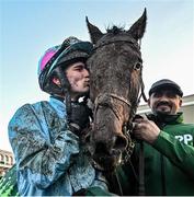 27 December 2023; Jockey Danny Mullins kisses Meetingofthewaters alongside groom Imran Haider after winning the Paddy Power Steeplechase on day two of the Leopardstown Christmas Festival at Leopardstown Racecourse in Dublin. Photo by David Fitzgerald/Sportsfile