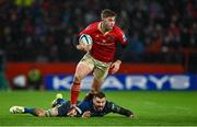26 December 2023; Jack Crowley of Munster breaks away from Max Deegan of Leinster during the United Rugby Championship match between Munster and Leinster at Thomond Park in Limerick. Photo by Brendan Moran/Sportsfile