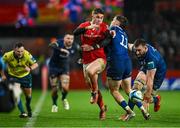 26 December 2023; Jack Crowley of Munster is tackled by Rob Russell of Leinster during the United Rugby Championship match between Munster and Leinster at Thomond Park in Limerick. Photo by Brendan Moran/Sportsfile