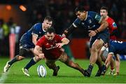 26 December 2023; Eoghan Clarke of Munster in action against Luke McGrath and Michael Ala’alatoa of Leinster during the United Rugby Championship match between Munster and Leinster at Thomond Park in Limerick. Photo by Brendan Moran/Sportsfile