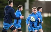 28 December 2023; Martin Moloney, right, offloads to Brian Deeny during a Leinster rugby squad training session at UCD in Dublin. Photo by Eóin Noonan/Sportsfile