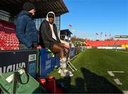 29 December 2023; Injured Munster player Edwin Edogbo watches the warm ups before the Challenge Match between Ireland U20 and Munster Development XV at Musgrave Park in Cork. Photo by Eóin Noonan/Sportsfile