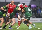 1 January 2024; Tom Ahern of Munster is tackled by Mack Hansen and Bundee Aki of Connacht during the United Rugby Championship match between Connacht and Munster at The Sportsground in Galway. Photo by Piaras Ó Mídheach/Sportsfile