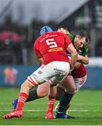 1 January 2024; Peter Dooley of Connacht is tackled by Tadhg Beirne, left, Tony Butler of Munster and during the United Rugby Championship match between Connacht and Munster at The Sportsground in Galway. Photo by Seb Daly/Sportsfile