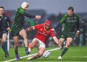 1 January 2024; John Hodnett of Munster in action against Mack Hansen, left, and Jack Carty of Connacht during the United Rugby Championship match between Connacht and Munster at The Sportsground in Galway. Photo by Seb Daly/Sportsfile
