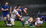 1 January 2024; Joe McCarthy of Leinster is tackled by Iain Henderson, left, and Tom O'Toole of Ulster during the United Rugby Championship match between Leinster and Ulster at RDS Arena in Dublin. Photo by Ramsey Cardy/Sportsfile
