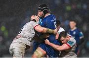 1 January 2024; Caelan Doris of Leinster is tackled by Nick Timoney, left, and Sean Reffell of Ulster during the United Rugby Championship match between Leinster and Ulster at RDS Arena in Dublin. Photo by Ramsey Cardy/Sportsfile