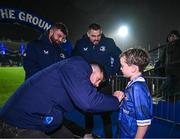 1 January 2024; Leinster match day mascot James McHugh, aged six, with Leinster players Ross Byrne, Michael Milne and Max Deegan before the United Rugby Championship match between Leinster and Ulster at the RDS Arena in Dublin. Photo by Harry Murphy/Sportsfile