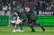 1 January 2024; Rory Scannell of Munster is tackled by Connacht players Jack Carty, 22, and Shamus Hurley-Langton during the United Rugby Championship match between Connacht and Munster at The Sportsground in Galway. Photo by Seb Daly/Sportsfile