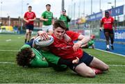 3 January 2024; Jack Giles of North East scores his side's first try despite the tackles of Zak Hernan, centre, and Joshua Clarke of South East Area during the BearingPoint Shane Horgan Cup Round 3 match between South East and North East at Energia Park in Dublin. Photo by Ben McShane/Sportsfile