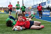 3 January 2024; Jack Giles of North East scores his side's first try despite the tackles of Zak Hernan, centre, and Joshua Clarke of South East Area during the BearingPoint Shane Horgan Cup Round 3 match between South East and North East at Energia Park in Dublin. Photo by Ben McShane/Sportsfile