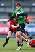 3 January 2024; Oscar O'Connor of South East Area is tackled by Thomas Stewart, left, and Cormac Fagan of North East during the BearingPoint Shane Horgan Cup Round 3 match between South East and North East at Energia Park in Dublin. Photo by Ben McShane/Sportsfile