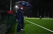 3 January 2024; Cork manager John Cleary takes shelter from the rain before the McGrath Cup Group B match between between Clare and Cork at Clarecastle GAA Astro Pitch in Clarecastle, Clare. Photo by Eóin Noonan/Sportsfile