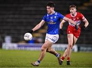 3 January 2024; Oisín Brady of Cavan passes under pressure from Ruairí Forbes of Derry during the Bank of Ireland Dr McKenna Cup Group B match between Cavan and Derry at Kingspan Breffni in Cavan. Photo by Piaras Ó Mídheach/Sportsfile