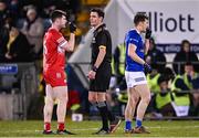 3 January 2024; Referee James Lewis with Padraig McGrogan of Derry and Oisín Kiernan of Cavan as they adjust their gum shields during the Bank of Ireland Dr McKenna Cup Group B match between Cavan and Derry at Kingspan Breffni in Cavan. Photo by Piaras Ó Mídheach/Sportsfile