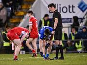 3 January 2024; Referee James Lewis waits as Padraig McGrogan of Derry and Oisín Kiernan of Cavan locate their gum shields during the Bank of Ireland Dr McKenna Cup Group B match between Cavan and Derry at Kingspan Breffni in Cavan. Photo by Piaras Ó Mídheach/Sportsfile