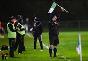 3 January 2024; Linesman Declan Nugent uses a Stradbally GAA flag to signal for a substitute during the Dioralyte O'Byrne Cup Round 1 match between Laois and Offaly at Stradbally GAA Grounds in Stradbally, Laois. Photo by Harry Murphy/Sportsfile