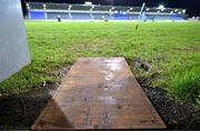 4 January 2024; A board marked out like a GAA pitch is used to cross a muddy patch of ground before the Dioralyte Walsh Cup Round 1 match between Dublin and Westmeath at Parnell Park in Dublin. Photo by Sam Barnes/Sportsfile