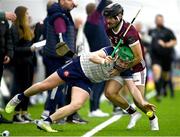 4 January 2024; Aidan Organ of New York attempts to keep the sliotar in play despite pressure from MacDara Ó'Bearra of Galway during the Connacht Hurling League semi-final match between Galway and New York at University of Galway Connacht GAA AirDome in Bekan, Mayo. Photo by Tyler Miller/Sportsfile