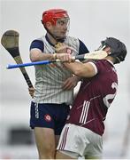 4 January 2024; AJ Willis of New York and MacDara Ó'Bearra of Galway tussle during the Connacht Hurling League semi-final match between Galway and New York at University of Galway Connacht GAA AirDome in Bekan, Mayo. Photo by Tyler Miller/Sportsfile