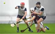 4 January 2024; Tommy Halliday of Galway is tackled by Ger McPartland of New York, left, and Adam Loughlin Stones during the Connacht Hurling League semi-final match between Galway and New York at University of Galway Connacht GAA AirDome in Bekan, Mayo. Photo by Tyler Miller/Sportsfile
