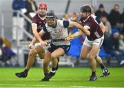 4 January 2024; Martin Cullen of New York is tackled by Fergus Hanney of Galway, left, and Keith Gleeson during the Connacht Hurling League semi-final match between Galway and New York at University of Galway Connacht GAA AirDome in Bekan, Mayo. Photo by Tyler Miller/Sportsfile
