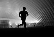 5 January 2024; (EDITORS NOTE: Image has been shot in black and white. Colour version not available.) Sligo footballer Paul Kilcoyne warms-up before the Connacht FBD League quarter-final match between Sligo and Roscommon at University of Galway Connacht GAA AirDome in Bekan, Mayo. Photo by Piaras Ó Mídheach/Sportsfile