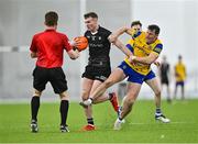 5 January 2024; Alan Reilly of Sligo fends off Diarmuid Murtagh of Roscommon as referee Shane Corcoran looks on during the Connacht FBD League quarter-final match between Sligo and Roscommon at University of Galway Connacht GAA AirDome in Bekan, Mayo. Photo by Piaras Ó Mídheach/Sportsfile