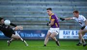 6 January 2024; Páraic Hughes of Wexford scores his side's third goal despite the efforts of Kildare goalkeeper Didier Cordonnier, left,  and Harry O'Neill of Kildare during the Dioralyte O'Byrne Cup quarter-final match between Wexford and Kildare at Chadwicks Wexford Park in Wexford. Photo by Sam Barnes/Sportsfile