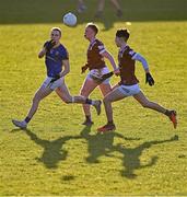 6 January 2024; Patrick Fox of Longford handpasses despite the attention of Shane Hanley, centre, and Jack Duncan of Westmeath during the Dioralyte O'Byrne Cup quarter-final match between Longford and Westmeath at Glennon Brothers Pearse Park in Longford. Photo by Ben McShane/Sportsfile