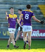 6 January 2024; Wexford players Páraic Hughes, left, and Liam Coleman celebrate after their side's victory in the Dioralyte O'Byrne Cup quarter-final match between Wexford and Kildare at Chadwicks Wexford Park in Wexford. Photo by Sam Barnes/Sportsfile