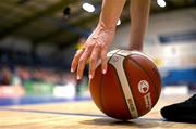 6 January 2024; An official picks up a ball during the Basketball Ireland Pat Paudie O'Connor Cup semi-final match between Pyrobel Killester and Gurranabraher Credit Union Brunell at Neptune Stadium in Cork. Photo by Eóin Noonan/Sportsfile